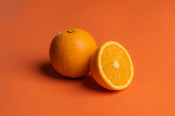 orange juicy oranges on an orange background.