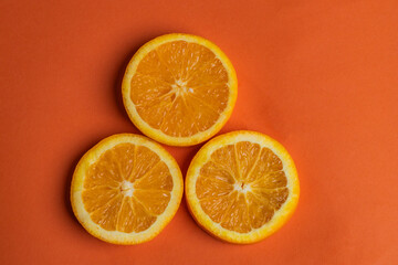 
juicy sweet orange slices on an orange background.