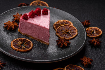 Raspberry or strawberry cheesecake, a slice of sweet red cake with berries. Raspberry cheesecake