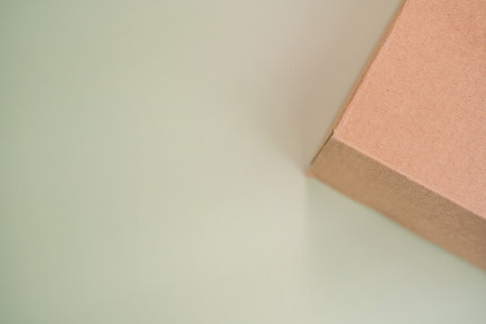 Mock-up of recycled eco friendly cardboard box, product and paracel packaging isolated on green background. Horizontal orientation with negative space for text