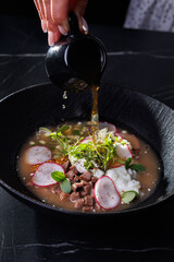 Soup Bowl With Radish, Beef, Eggs, Greens, And Delicate Golden Broth Pour