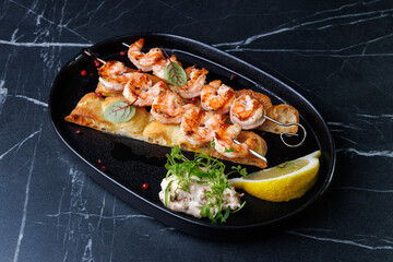 Gourmet Shrimp Skewers on Crispy Bread with Lemon Wedge and Fresh Green