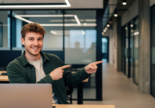 Team member in open plan hub pointing toward copy area useful for internal portal headers about workflow updates or feature announcements in flexible desk environmental rules