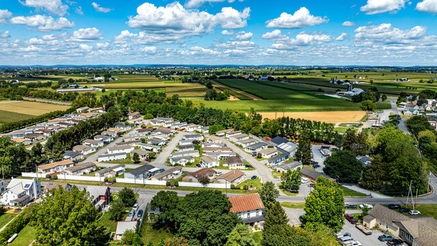 Aerial perspective shows a peaceful rural neighborhood with houses organized in a circular layout.
