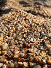 Vertical photo close-up of pebbles on a seaside shore.