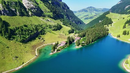 Seealpsee lake in Swiss alps in summer. Alpstein mountain range in Switzerland. The lake near Wasserauen and Ebenalp. popular hiking tourism destination.