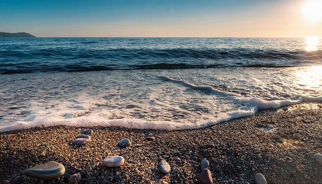 close up of pebbles along a shoreline with gentle waves lapping the beach - Powered by Adobe