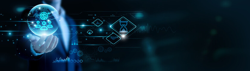 Businessman hand hold Project Management and global networking, aligning workflows. Agile planning boosts delivery, collaborative tools ensure milestone success.