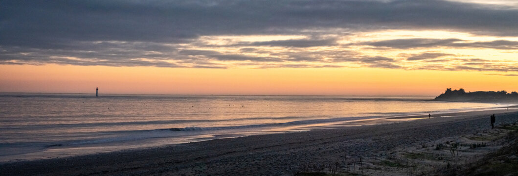 Panorama of Re island seascape with a little lighthouse in the horizon at sunset on a very calm sea. beautiful minimalist seascape.