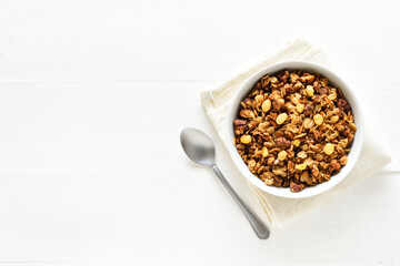 Granola in bowl over light wooden background