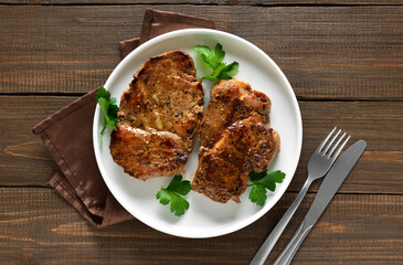 Roasted pork steaks on plate
