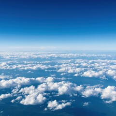 A massive expanse of blue atmosphere stretching to the horizon, filled with soft white cumulus clouds on a clear, sunny day, heaven, tranquil, vast