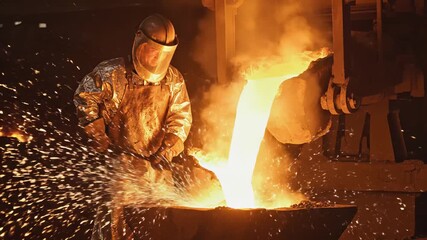 Skilled worker in protective gear pours molten metal into a mold, showcasing the intense heat and sparks, with dynamic camera movement capturing the action - Powered by Adobe