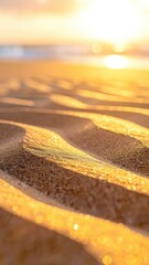 Golden sunrise over glistening, rippled sand on a tranquil beach shore