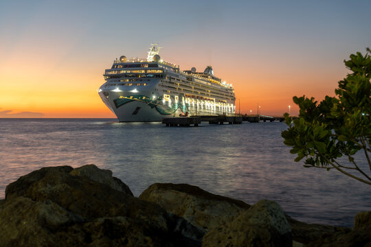 Willemstad, Curacao: Norwegian Jade cruise ship in moored in Cura&ccedil;ao with a stunning sunset. Norwegian Cruise Line (NCL). Mega Cruise Terminal near Renaissance Park.