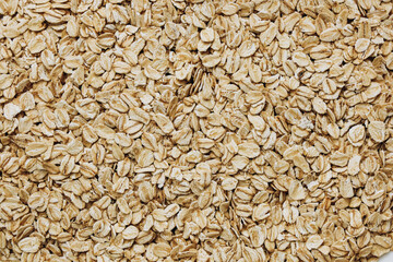Oats spread out on a surface ready for cooking or baking in a rustic kitchen setting