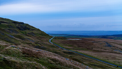 Winding mountain road crossing remote rural landscape