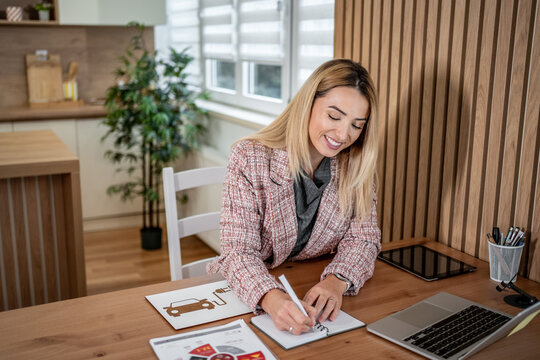 Woman planning electric car purchase for sustainable living