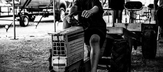 Selective focus on a pedal tractor pull and sled at a county fair © Lost_in_the_Midwest