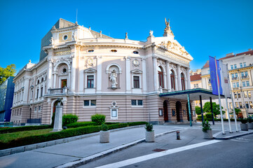 Ljubljana, Slovenia &ndash; July 14, 2025: The front fa&ccedil;ade of the Slovenian National Opera and Ballet Theatre glows under the clear summer sky.
