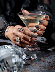 hands of a woman with a glass of champagne, martini glass, Holiday party, corporate event, new year celebration