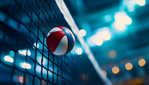 Volleyball ball hits net in arena. Dramatic stadium lights shine on sport game. Players compete in match on court. Fast action,