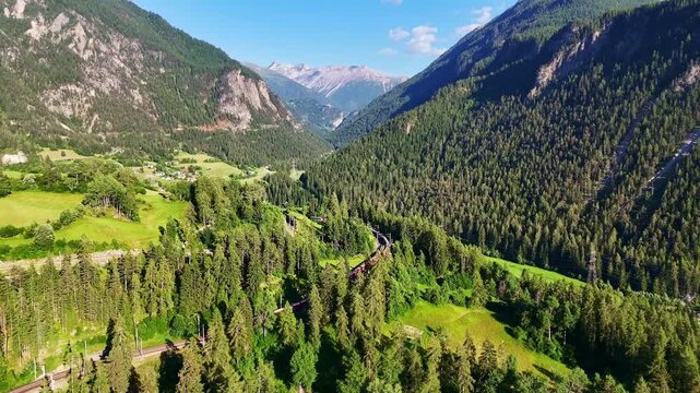 red swiss train on Landwasser viaduct bridge in Swiss Alps. Zermatt to St. Moritz.  scenic railway. Switzerland summer tourism.