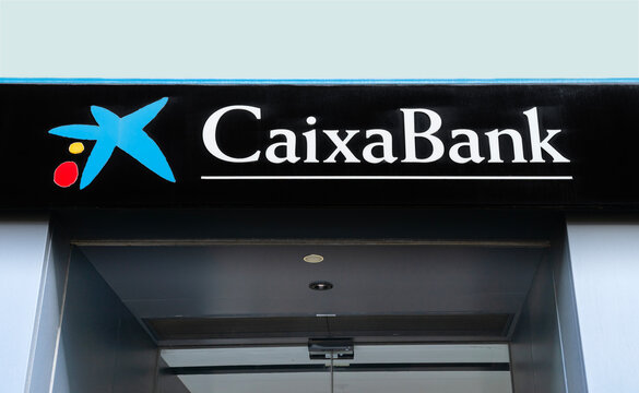 Seville, Spain; October 15, 2025; Caixabank logo sign on branch facade.	