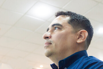 Portrait of a serious Colombian man attending a conference in an auditorium at a convention center in Neiva, Huila, Colombia. Concept of Colombian people