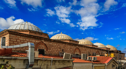 Fototapeta premium Historic domes of the Grand Bazaar roof under a blue sky in Istanbul, Turkey