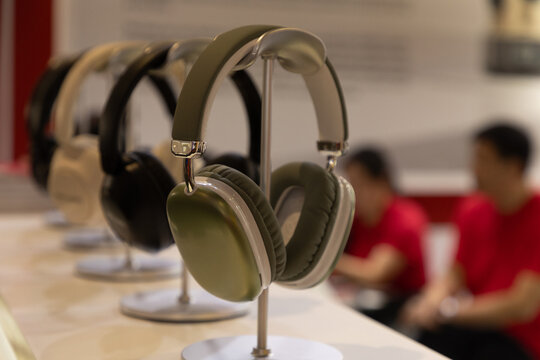 Stylish headphones displayed on stands in modern retail environment