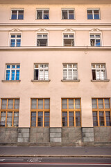 Ljubljana, Slovenia – July 14, 2025: A quiet residential scene shows neighboring apartment buildings in warm pastel tones, complete with balconies and rooftop chimneys
