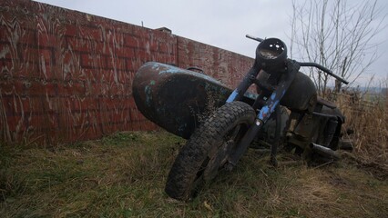 old motorcycle by wrecked plane, decaying motorcycle and aircraft fused with natural overgrowth