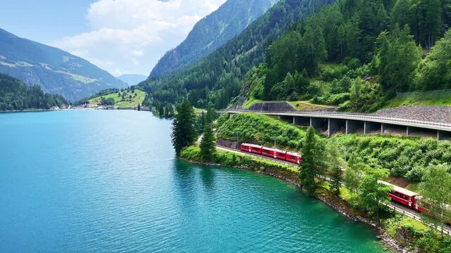 Drone Switzerland 4k. Swiss Alps. Rhaetian Railway famous Lake Bianco on way to St. Moritz. Switzerland summer tourism.