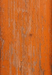Naklejka premium Weathered wooden door featuring layers of vibrant orange paint flaking away, revealing aged wood grain texture, forgotten, decay, facade