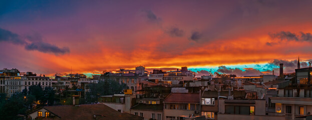 Dramatic sunset over Istanbul Turkey cityscape with colorful clouds and rooftops