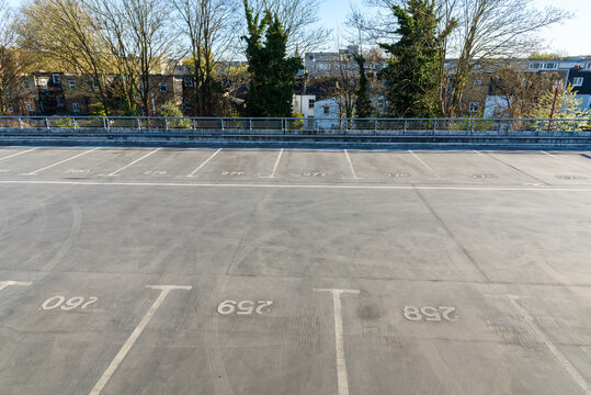 Deserted parking spaces on the top floor of a mult-storey car park on a sunny spring day
