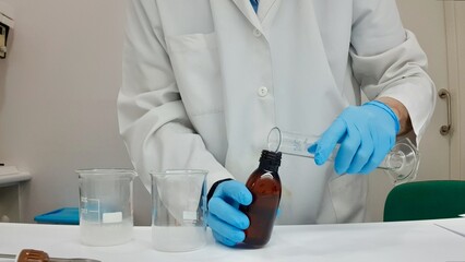 Pharmacist compounding medicine in a laboratory setting