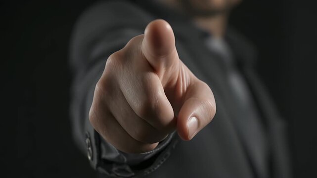 Man in Suit Points Finger Forward in Business Context.