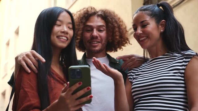 Group of multi ethnic friends looking at smartphone and laughing