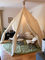 Home made tent made with chairs and bed sheets in the living room