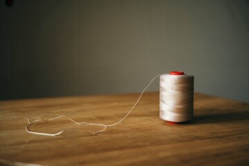 Spool of thread on wood table