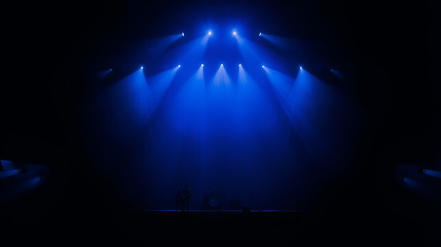 Blue light on dark stage - Powered by Adobe