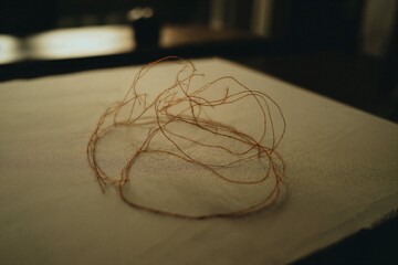 Tangled thread on a white surface