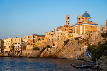 Fototapeta premium Venetian architecture of Ermoupoli and the dome and bell towers of Saint Nicholas church on the Greek island of Syros