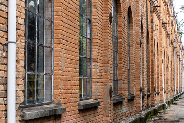 Fototapeta premium The arched windows of an old factory hall built of beautifully red bricks