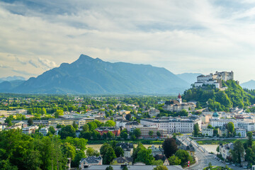 Obraz premium Salzburg City and Hohensalzburg Fortress on Sunny Summer Day. Mountains in Background. Austria