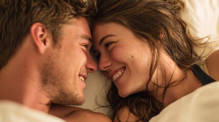 Intimate Portrait of a Smiling Young Couple Relaxing in Bed, Showing Love and Affection