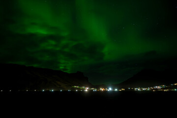 Aurora borealis or northern lights over fjord in Iceland