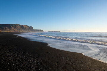 Black sand beach at Reynisfjara, Iceland. Atlantic ocean.